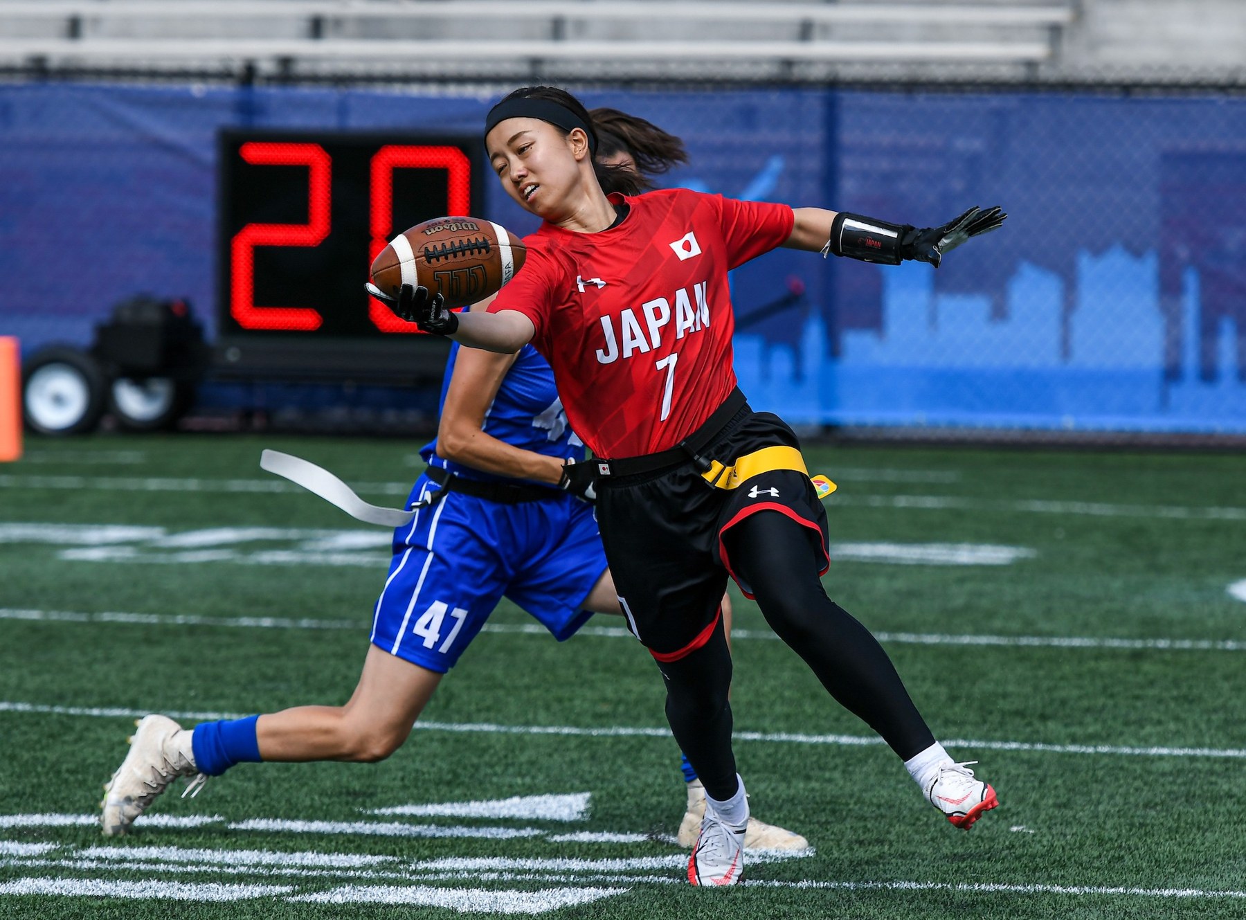 Japan women’s national-team athlete carrying the ball